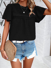 Black dotted swiss smocked bodice blouse with flutter sleeves and lace trim.