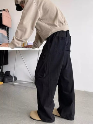 Black relaxed fit cargo pants with multiple pockets and drawstring waist.