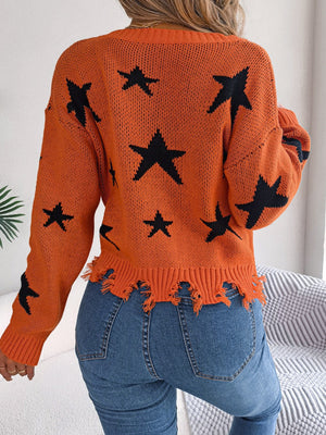 Orange distressed v-neck knit sweater with black star pattern and frayed hem.