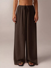 Brown maternity wide-leg pants with drawstring waist and relaxed fit.