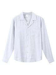 Relaxed camp collar button-up shirt in light blue with a chest pocket and buttoned cuffs.