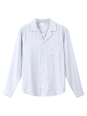 Relaxed camp collar button-up shirt in light blue with a chest pocket and buttoned cuffs.