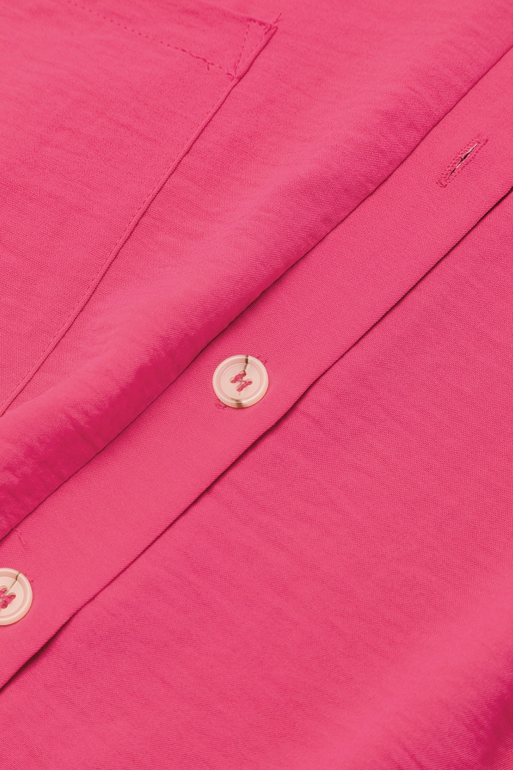 Hot Pink oversized shirt romper with button detail and pocket flap.