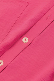 Hot Pink oversized shirt romper with button detail and pocket flap.