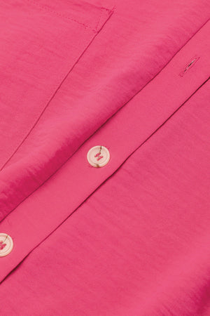 Hot Pink oversized shirt romper with button detail and pocket flap.