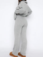 Gray ribbed knit lounge set with quarter-zip top and flared pants.