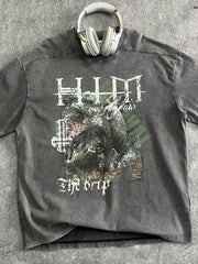 Acid wash graphic t-shirt in dark gray with a distressed monster graphic and text that reads "The Drip".