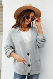 Light gray textured knit cardigan with oversized pockets and button front, styled with a white henley.
