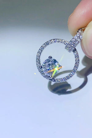 Silver halo moissanite circle pendant necklace with pavé accents.