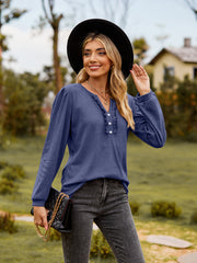 Navy ruffled henley blouse with button detail and long sleeves.