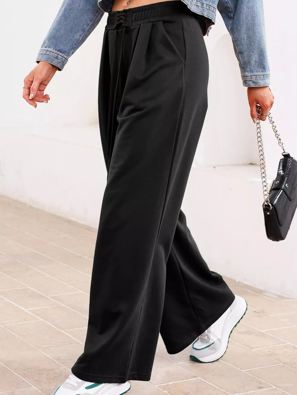 Black cotton drawstring high-waisted pleated maternity pants with a relaxed fit.
