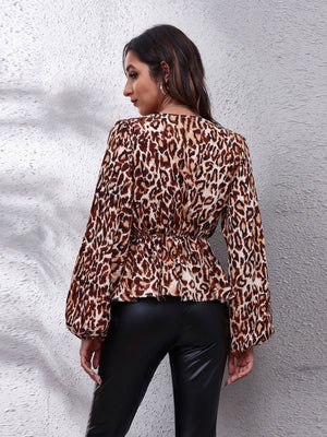 Leopard print peplum blouse with gathered waist and balloon sleeves.