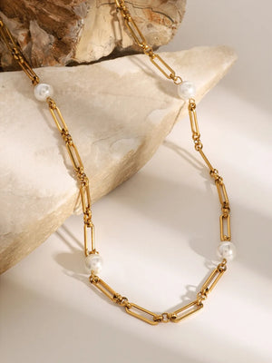 Gold two-tone pearl link necklace with elongated oval chain links and round pearls.