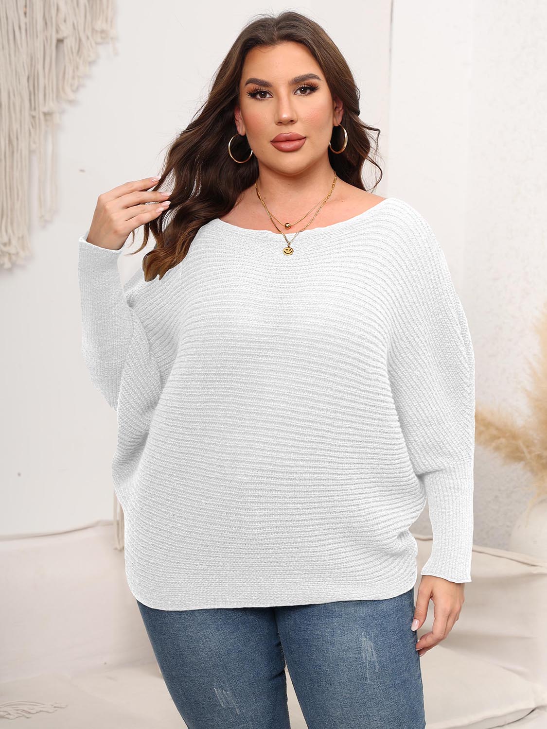 White ribbed knit off-shoulder sweater with batwing sleeves and a relaxed cocoon fit.