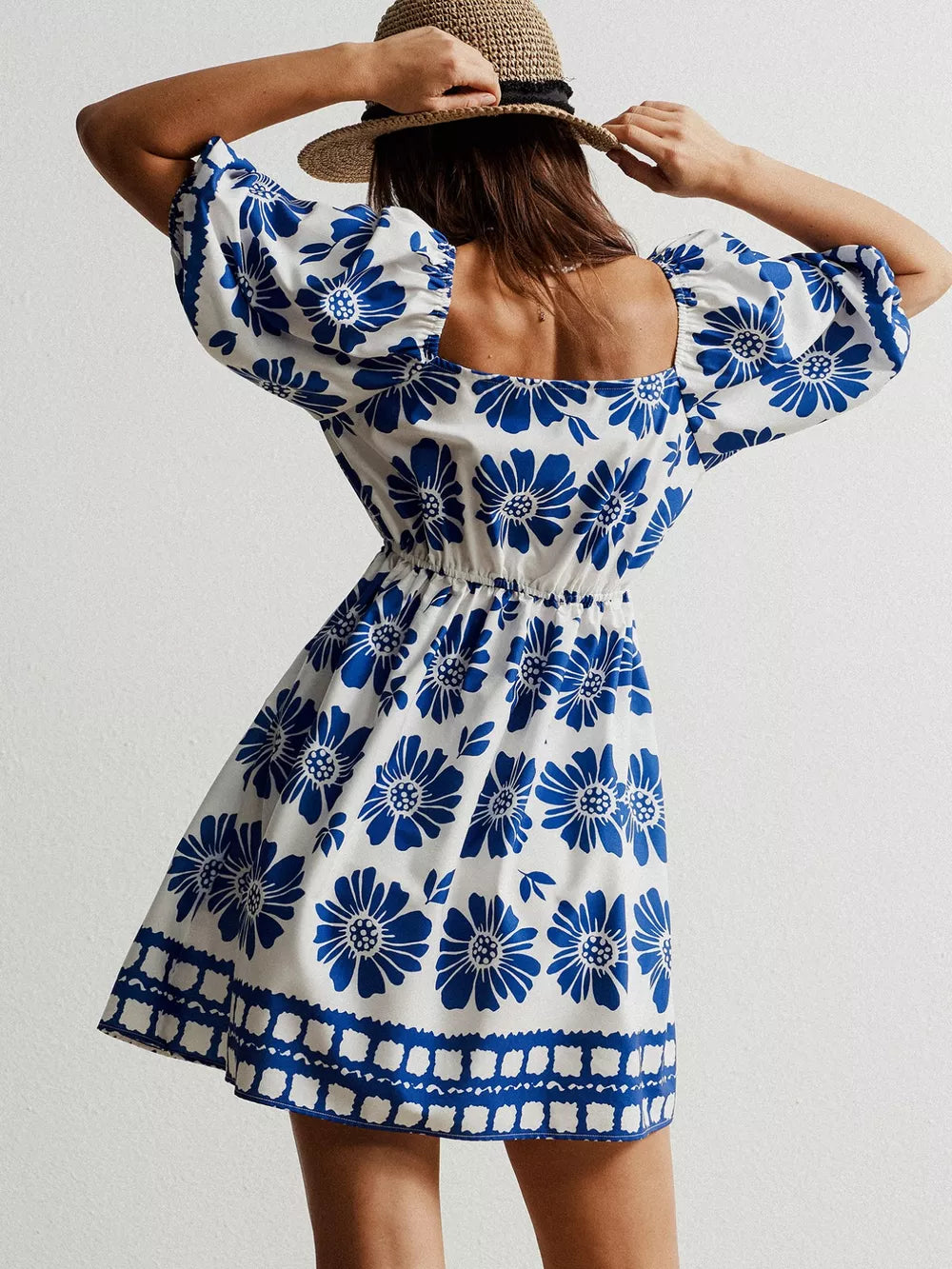 Blue floral puff sleeve mini dress with square neckline and smocked waist.