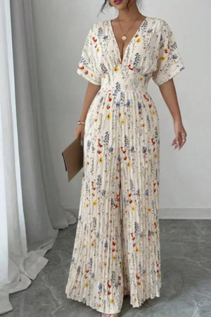 Floral pleated wide-leg jumpsuit with V-neck and short sleeves, cinched waist.