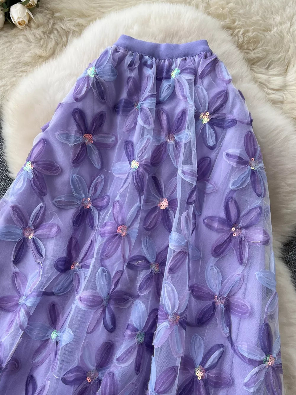 Purple layered midi skirt with embroidered floral appliques and sequins.