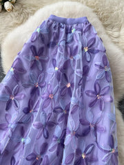 Purple layered midi skirt with embroidered floral appliques and sequins.