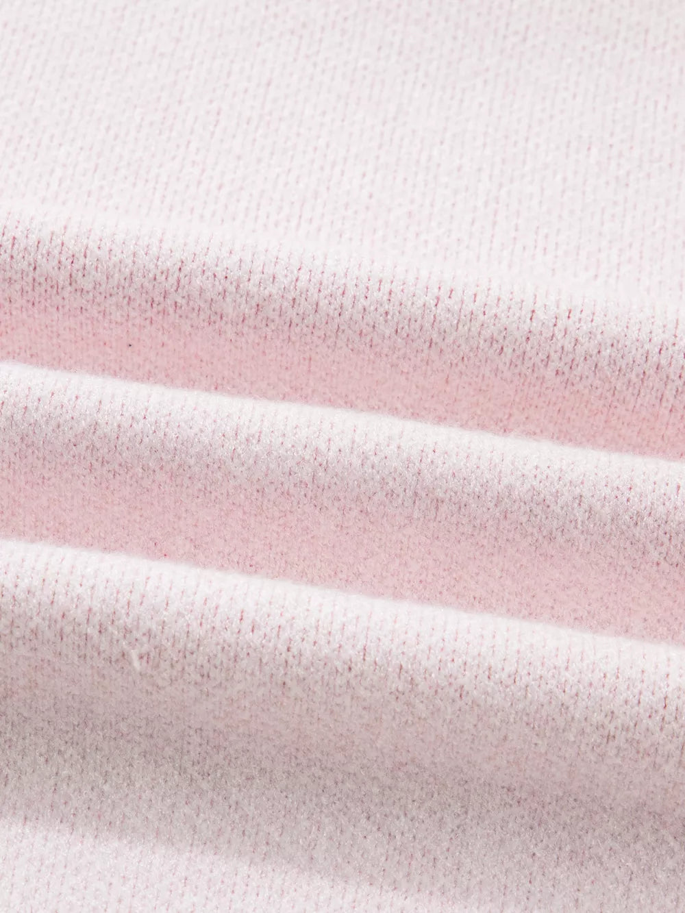 Blush pink knit sweater with a textured fabric detail.