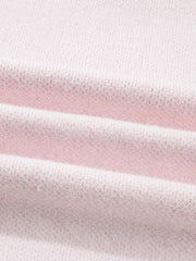 Blush pink knit sweater with a textured fabric detail.