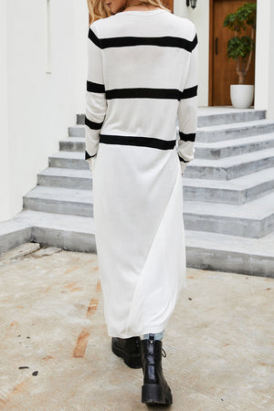 Longline white knit cardigan with black stripes, crew neck, and long sleeves.