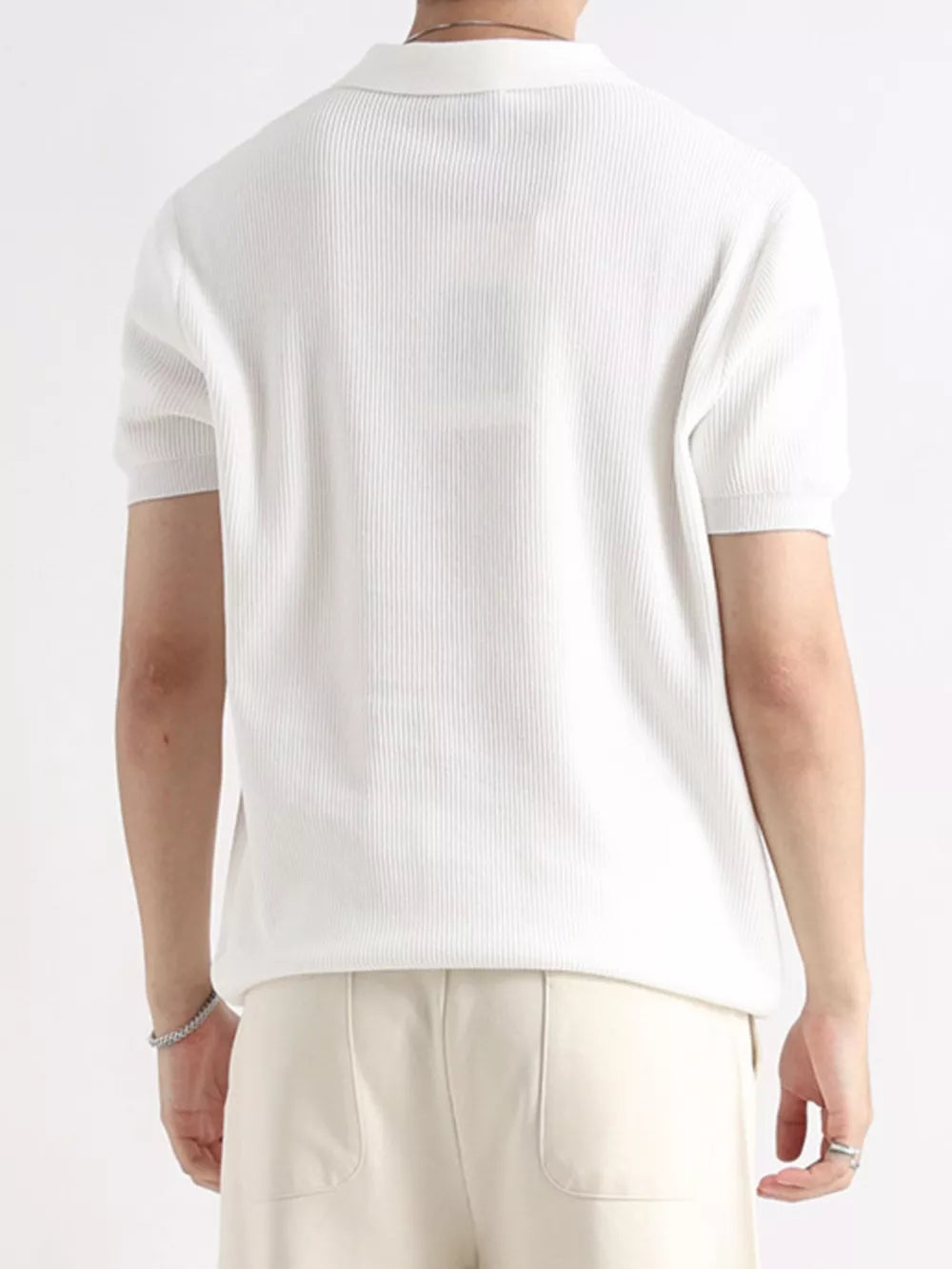 Men's white ribbed short sleeve polo shirt with classic collar.