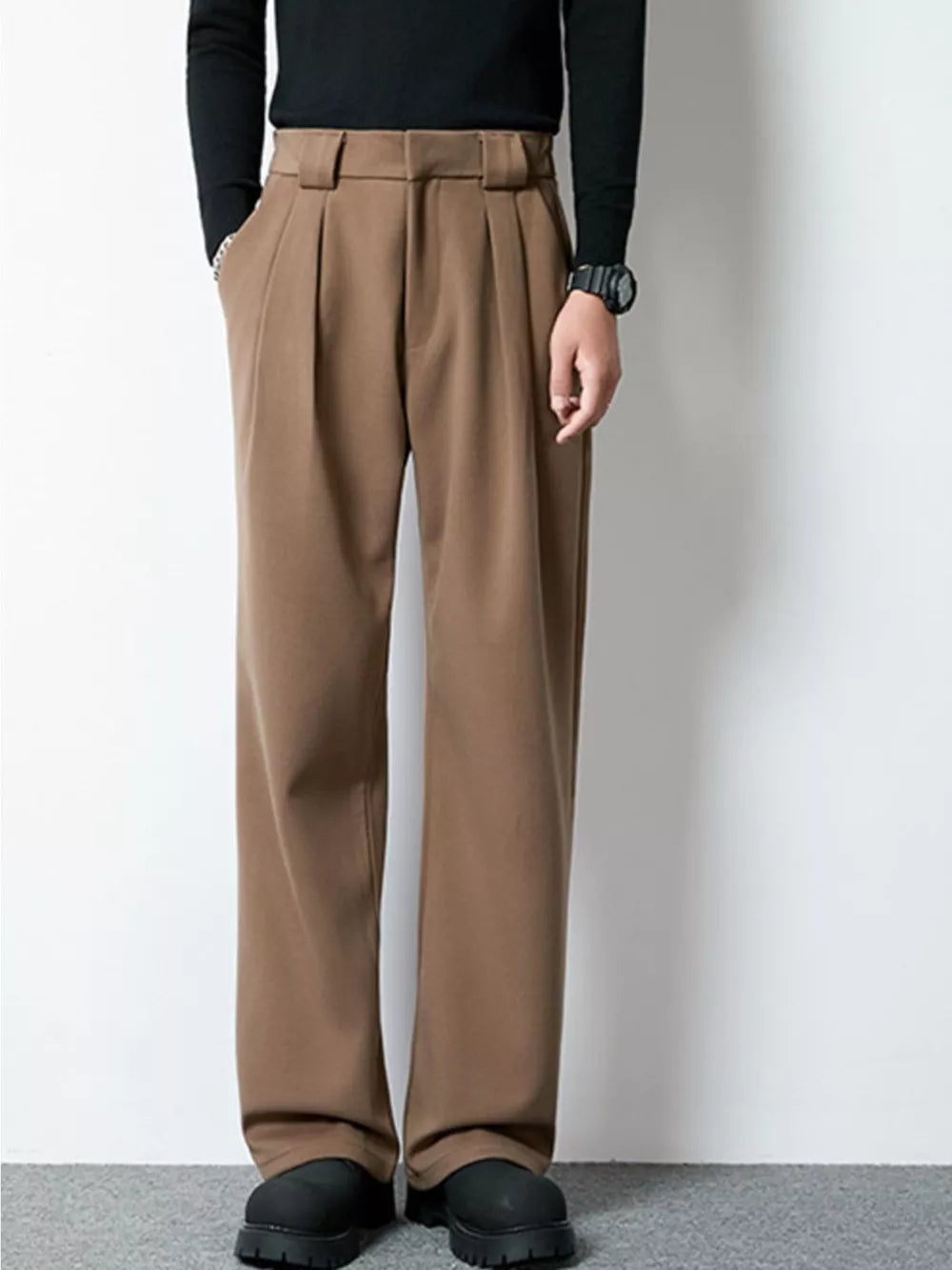 Men's dark brown wide-leg pleated dress pants with a relaxed fit.
