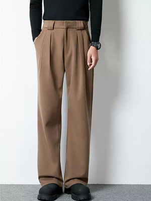Men's dark brown wide-leg pleated dress pants with a relaxed fit.