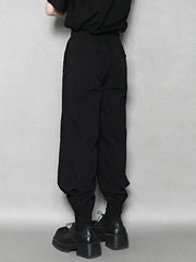 Black sweatpants with drawstring waist and elastic ankle cuffs.