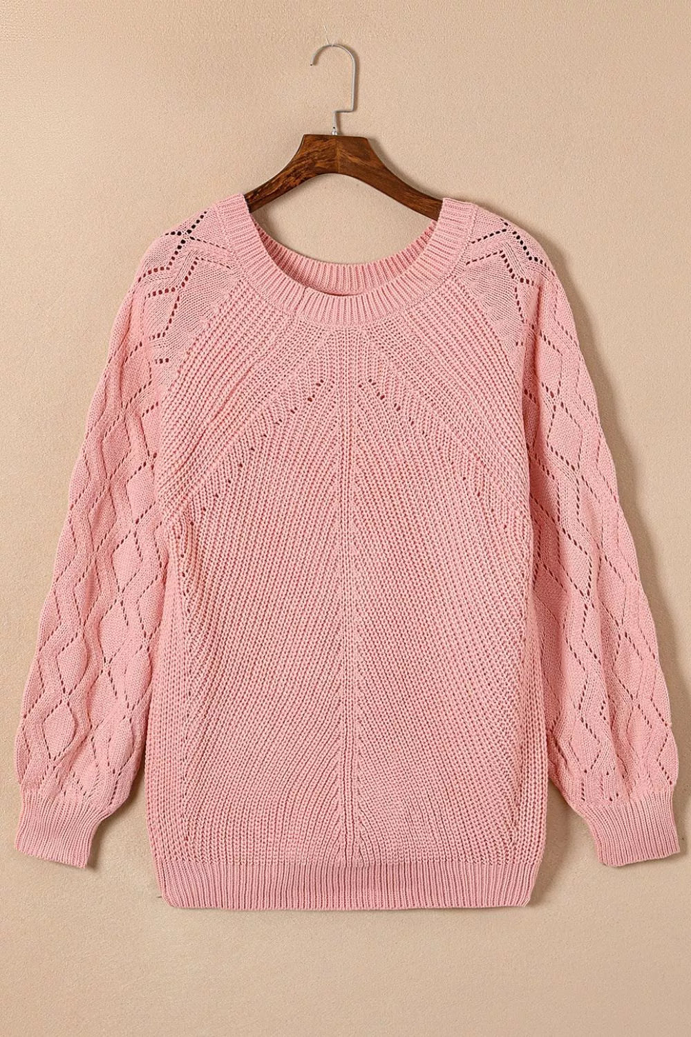 Dusty pink knit sweater with hollow-out diamond pattern on puffy sleeves and yoke.
