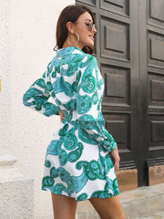 Shirred waist mini dress with paisley print in teal and white, long sleeves, collared neckline.