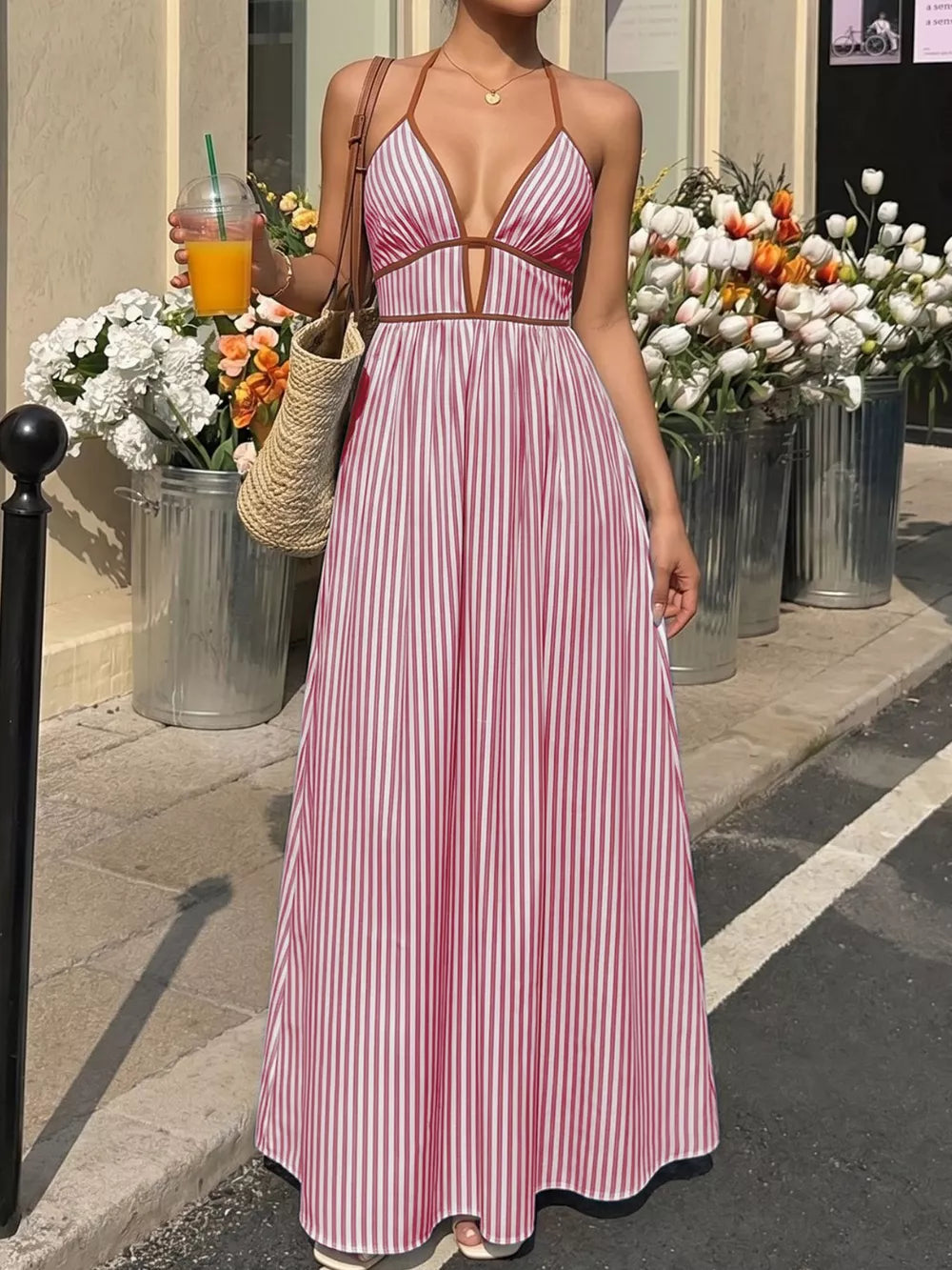 Burgundy striped halter maxi dress with plunging neckline and A-line skirt.