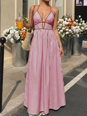 Burgundy striped halter maxi dress with plunging neckline and A-line skirt.