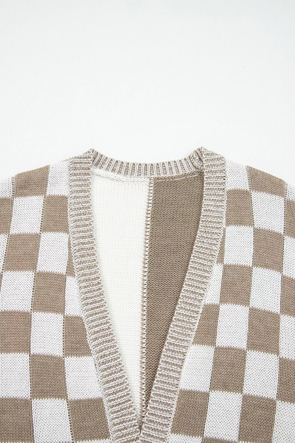 Checkerboard knit cardigan in brown and white acrylic with ribbed neckline and placket.