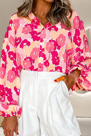 Floral print balloon sleeve blouse in strawberry pink with button front and casual cut.