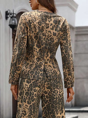 Sleek leopard print denim bolero jacket with collarless neckline and button-up front.