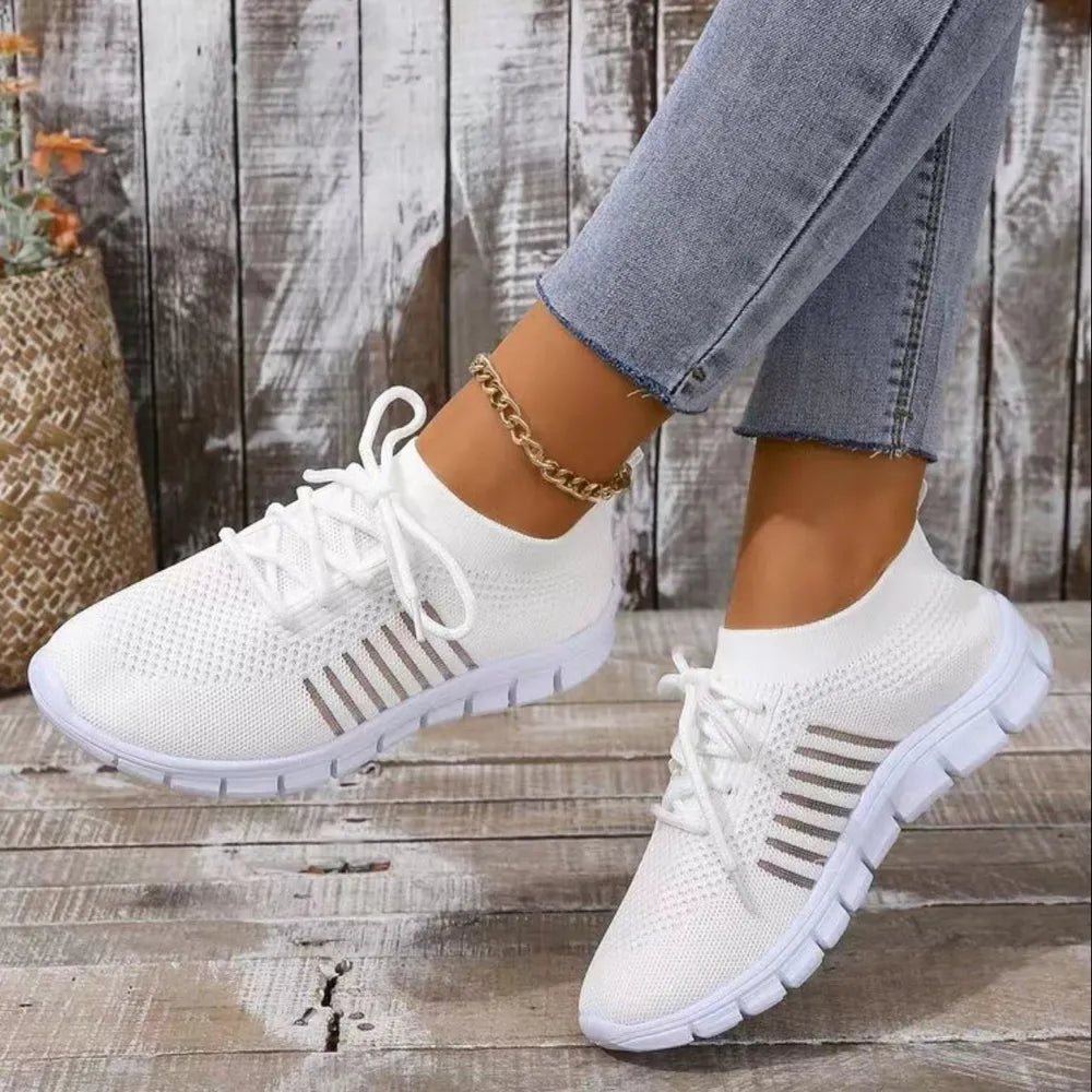 White knit runner sneakers with ribbed detail and lace-up closure.