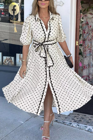 Charming polka dot midi dress with tie belt, button front, puff sleeves, and scalloped trim.
