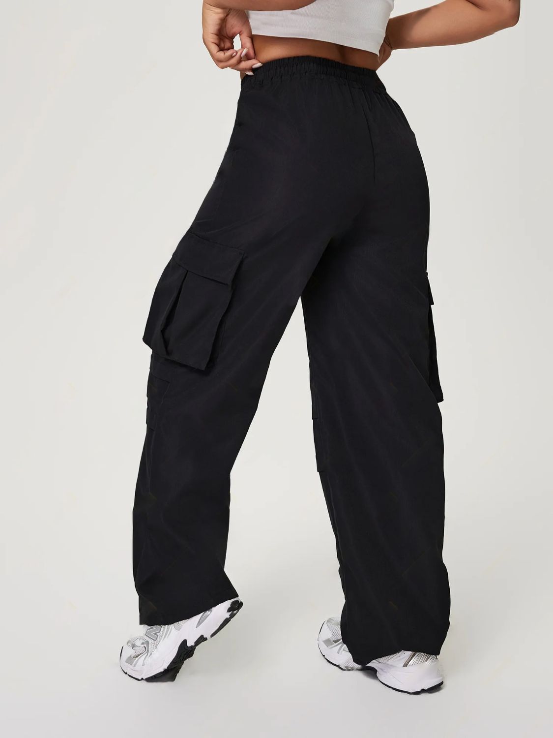 Black utility cargo pants with wide legs and multiple pockets.