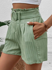 Light green pleated high-waist belted bermuda shorts with paperbag waist and side pockets.