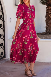 Charming floral tiered midi dress in magenta with short sleeves and a ruffled neckline.