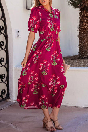 Charming floral tiered midi dress in magenta with short sleeves and a ruffled neckline.