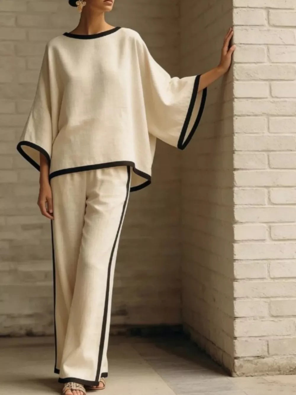 Apricot two-piece set with boat neck top and wide leg pants, featuring contrast black trim.