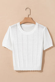 White eyelet knit puff sleeve top with scalloped hem and neckline.