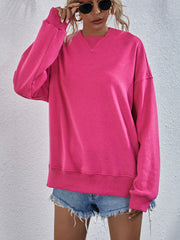 Boxy hot pink sweatshirt with V-neck detail and split hem