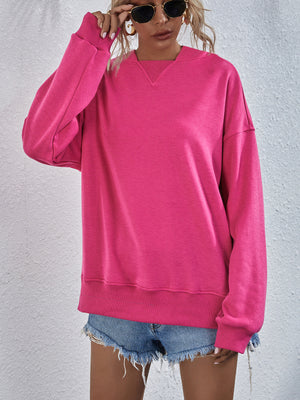 Boxy hot pink sweatshirt with V-neck detail and split hem