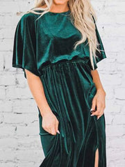 Green velvet maxi dress with flutter sleeves and cinched waist