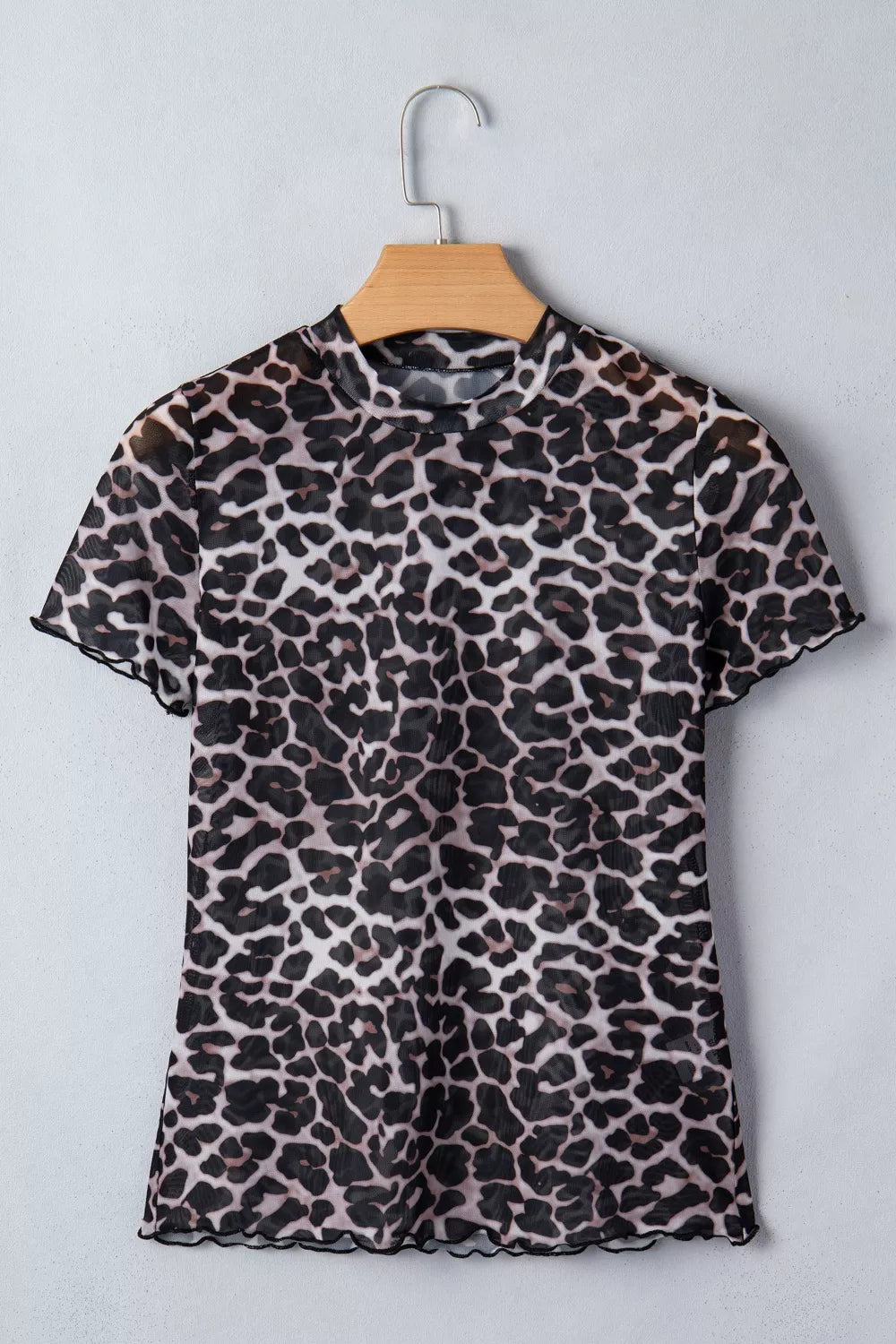 Leopard print sheer mesh t-shirt with mock neck and lettuce edge trim.