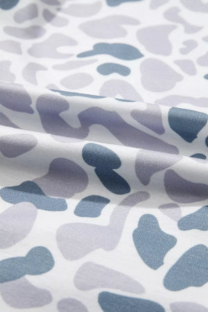 Camouflage print pajama fabric with blue and grey abstract shapes on white.