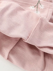 Blush pink cotton blend girls' undershirt with daisy graphic detail and comfortable fit.